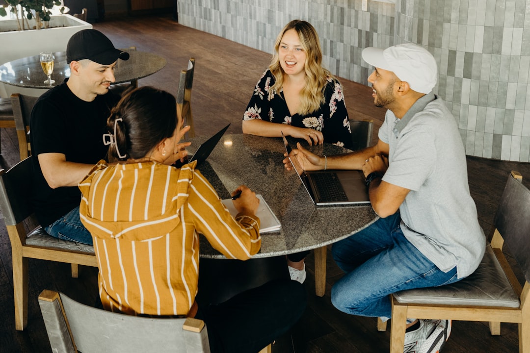 a-group-of-people-sitting-around-a-table-jikxrcinafa